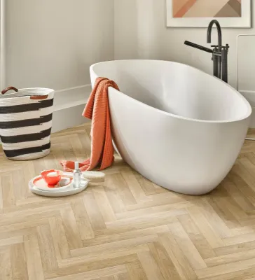 herringbone flooring install in bathroom